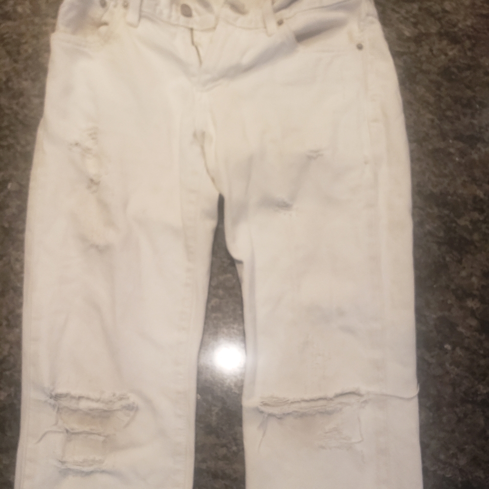 A levi white shinny ripped jeans